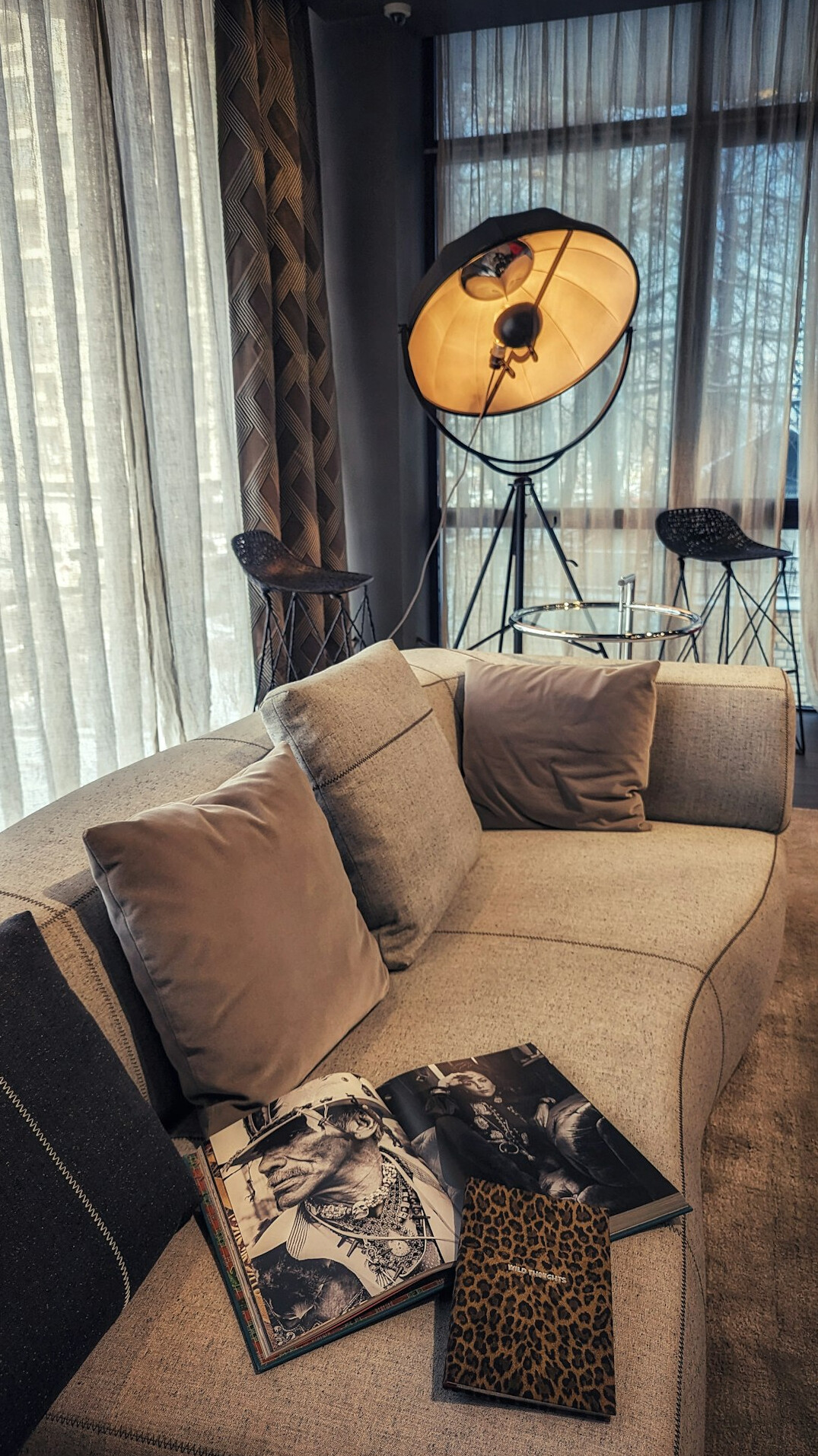 Modern editorial studio with soft lighting a camera on a tripod and a sofa