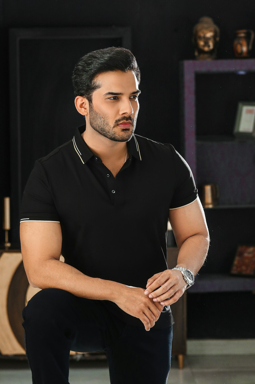Studio portrait of a Latino man in his forties with short dark hair and a polo shirt